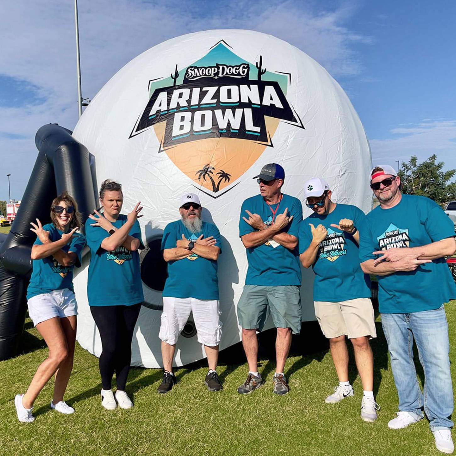 Blue Blazers members with the Arizona Bowl inflatable football